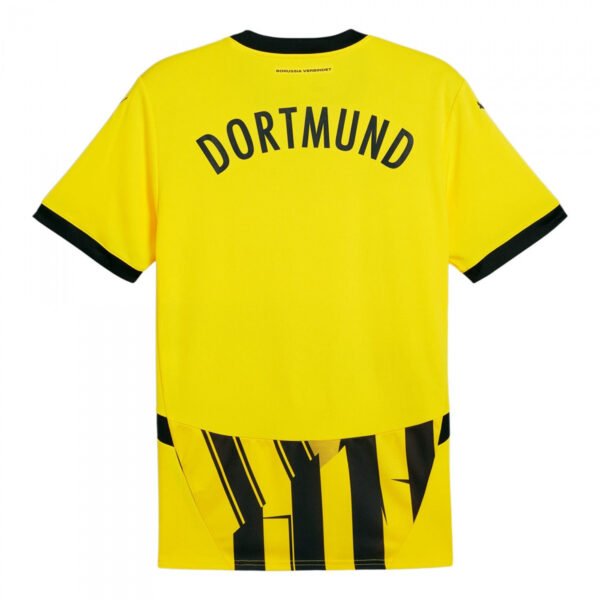The image displays the Borussia Dortmund Cup Jersey 24/25, featuring DORTMUND in bold black on a vibrant yellow. It has a black collar, sleek black cuffs, and an eye-catching graphic at the bottom.