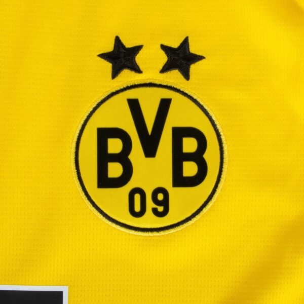 The Borussia Dortmund Home Jersey 23/24 features a yellow design with the Borussia Dortmund emblem, BVB 09 in black, two black stars above the circular logo, all highlighted against the vibrant fabric.
