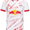 The Leipzig Home Jersey 24/25 is a white and red jersey featuring red abstract diagonal patterns. It showcases logos with two red bulls, a Puma logo on the chest, and the team logo on the upper left side, with a red collar and sleeve edges to complete its dynamic design.