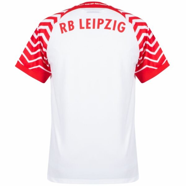 The image features the RB Leipzig Home Jersey 23/24, which is pristine white with striking red chevron patterns on the sleeves and RB LEIPZIG in bold red across the shoulders.