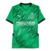 The Borussia Mönchengladbach Away Jersey 24/25 is a green jersey with black trim and a geometric pattern, featuring the Puma logo, a star-adorned crest, and Reuter boldly printed on the chest.