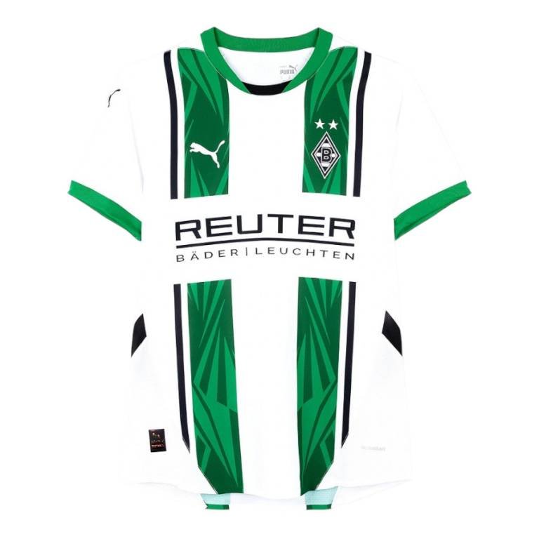 The Borussia Mönchengladbach Home Jersey 24/25 is a white and green jersey with geometric patterns, a diamond-shaped logo with stars, and the Puma logo on the chest. REUTER BÄDERLEUCHTEN is prominently printed across the front.