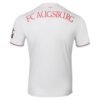 The image shows the FC Augsburg Home Jersey 24/25 with a pristine white design. FC AUGSBURG appears in red on the upper back, above 1907. A subtle black logo or text graces the sleeve, adding elegance to this iconic soccer apparel.