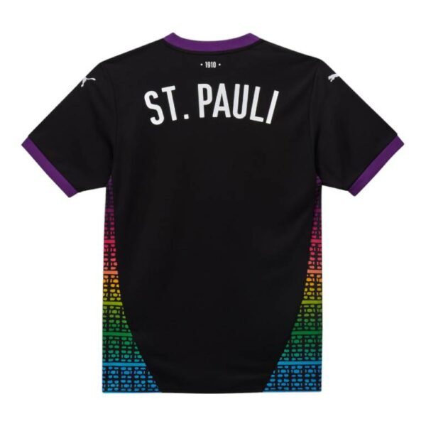 The rear view of the FC St. Pauli Third Jersey 24/25 prominently features ST. PAULI and 1910 on a sleek black background, with vibrant rainbow geometric patterns adorning the sleeves and sides.