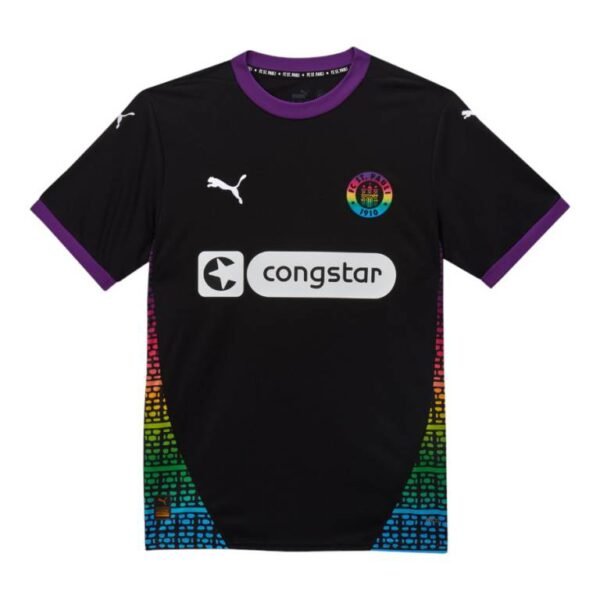 The FC St. Pauli Third Jersey 24/25 features a black design with purple accents on the collar and sleeves, a multicolored brick pattern on the sides, a rainbow-themed logo on the chest, and is completed with white Puma logos and a Congstar sponsor.