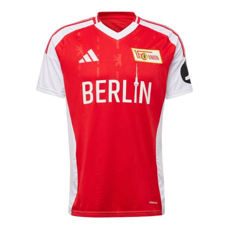 The Union Berlin Home Jersey 24/25 is red and white, featuring a Berlin text on the front, the club logo on the right chest, Adidas logo on the left chest, JD logo on the sleeve, and diagonal white stripes on the shoulders.